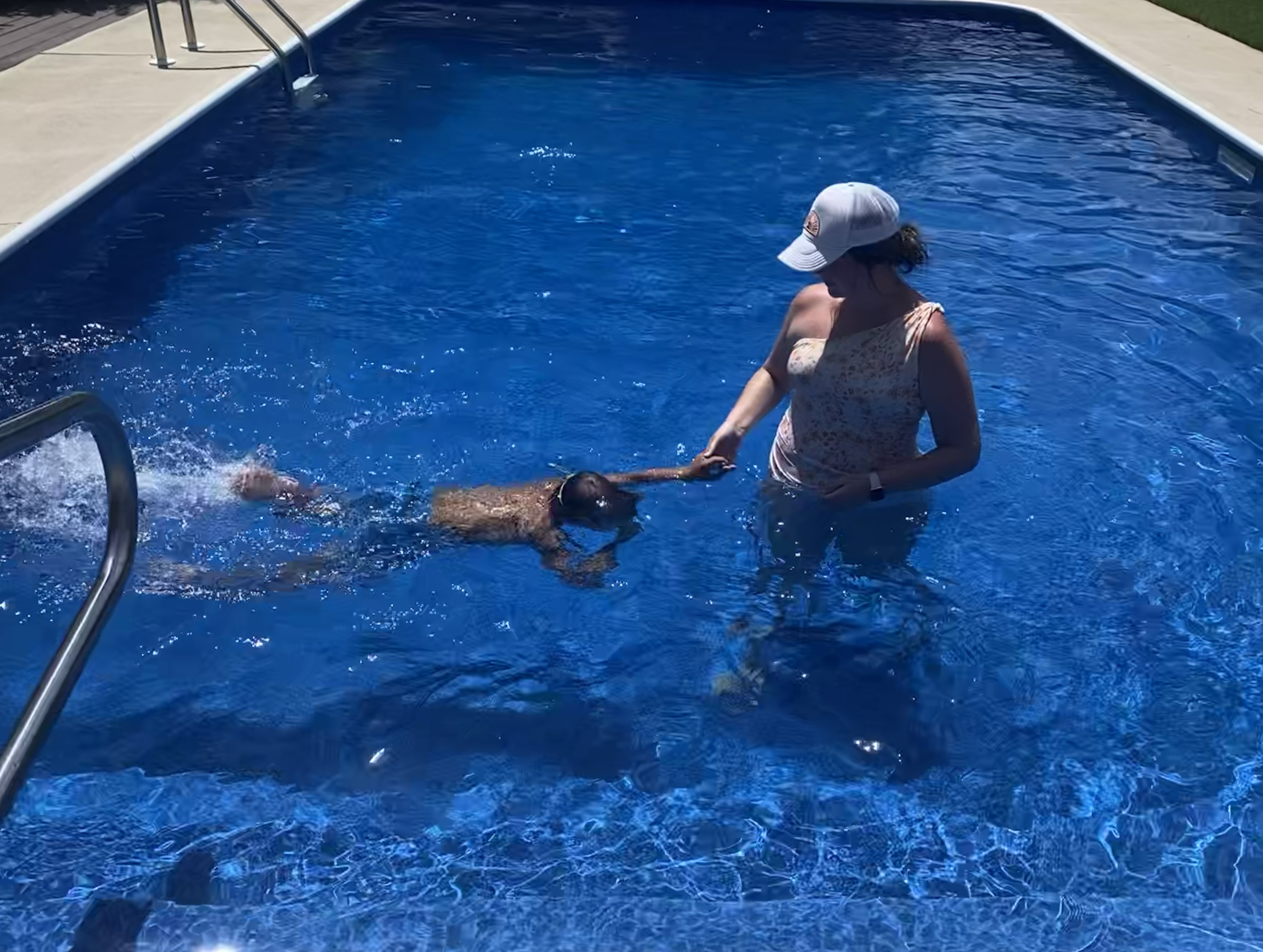 Child swimming underwater in pool